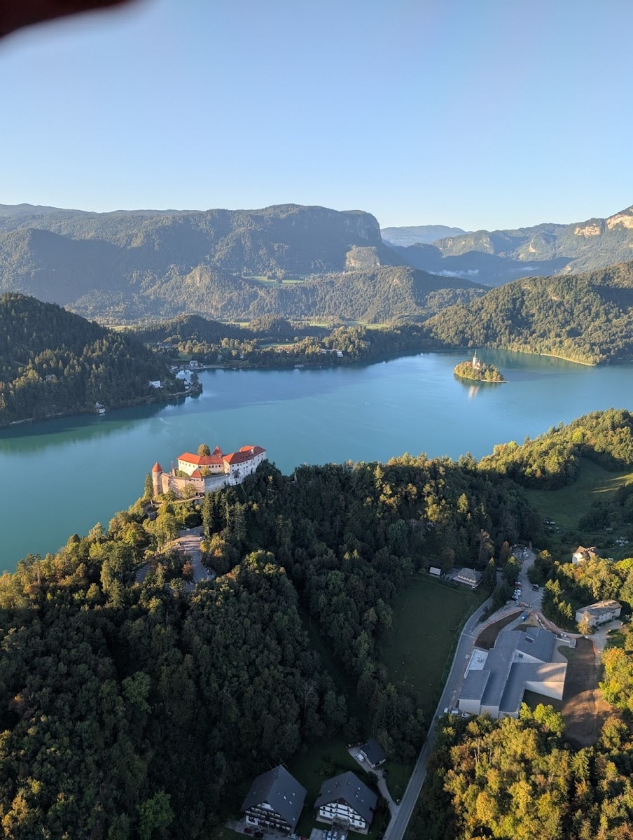 Lake Bled with Bled Castle on cliff and island church surrounded by mountains